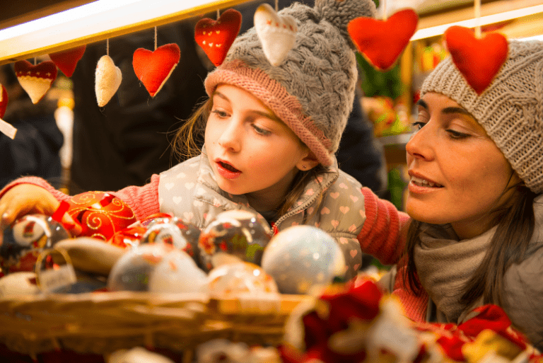 Woman and child enjoying a traditional Christmas market - A-Plan Insurance Top 10 Christmas Markets