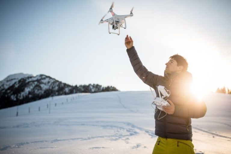 Man flying drone in snow - A-Plan Insurance