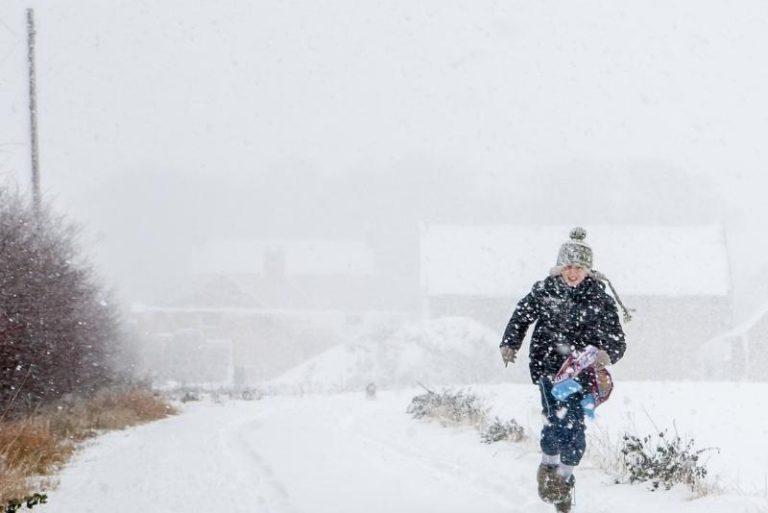 Boy running through snowy weather - A-Plan Insurance
